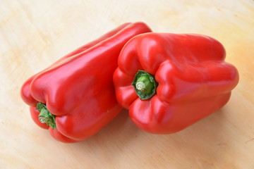Beautiful Fresh Red Peppers on Wooden Background