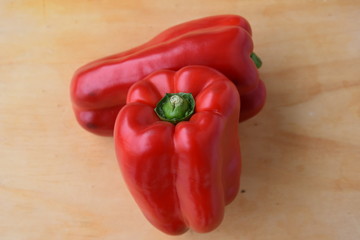 Beautiful Fresh Red Peppers on Wooden Background