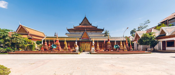 Wat Preah Prom Rath. Buddhist temple complex with gardens. Siem Reap, Cambodia. Panorama. - obrazy, fototapety, plakaty