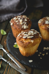 Fresh muffins with marzipan and almonds