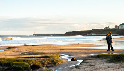 Panoramic View of Couple walking on the British Seaside at Sunset in Tynemouth, United Kingdom 02