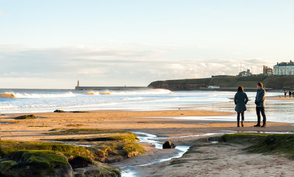 Panoramic View of Couple walking on the British Seaside at Sunset in Tynemouth, United Kingdom 01