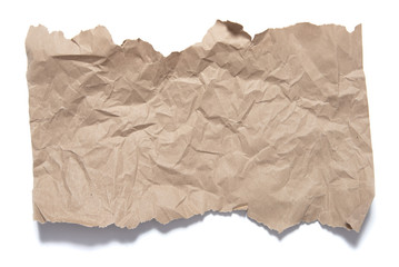 Fragment brown paper with torn edges and crumple traces. Object on white background with shadow