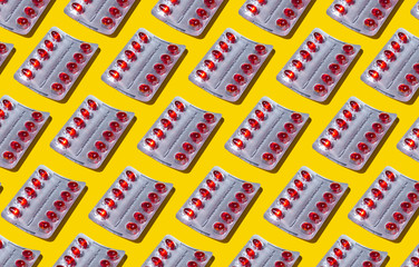 Blister red capsule medicine pharmacy pattern on yellow background