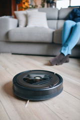 Robotic vacuum cleaner on wood floor in modern living room