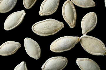 Pumpkin seeds isolated on black background. Close-up.