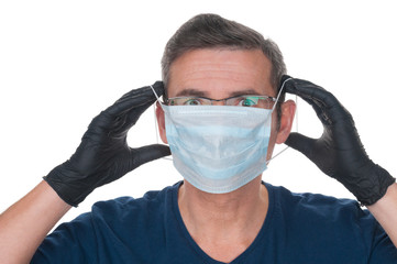 Adult man in latex gloves wearing medical mask on white background
