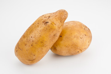 Ripe potatoes close up on white background