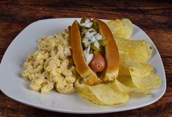 hot dog with macaroni salad and potato chips