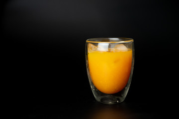 Freshly squeezed orange juice with ice cubes