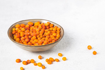 Organic sea buckthorn berries in a bowl