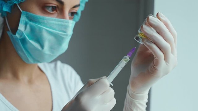 Close-up woman doctor hands in gloves holding syringe and vaccine. Prevention, immunization and treatment from corona virus, flue, infection. concept of vaccination, injection, medicine.