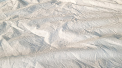 Obraz premium Wrinkle white Linen fabric cover the bed
