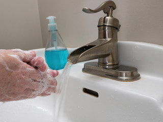 hand washing with soap at sink