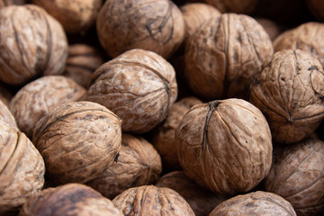 Walnuts in shell .Inshell walnuts close-up. Brown walnuts.