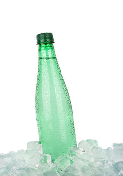 Plastic bottle of drinking water on ice over white