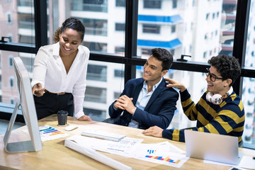A group of young business people working together while sitting at their desks in the office, Business meeting.