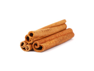 Close up three cinnamon sticks isolated on white