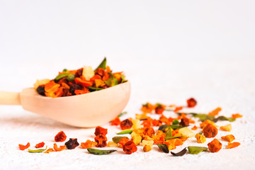 Super Food. Berry fruit drink In a wooden spoon on a white background. . Recovery after illness, virus. Immunity strengthening. Lingonberry, sea buckthorn, cranberry, lingonberry leaf, carrot, pineapp