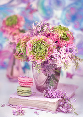 Beautiful bouquet of spring flowers in a vase on the table. Lovely bunch of flowers .Blue background.Pastel tonality.