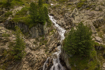 Fototapeta na wymiar Waterfall of brook in mountains of the French alps