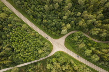 Cars driving on road through forest