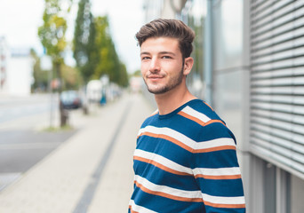 Portrait of young casual friendly man, selective focus