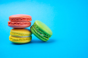 Macaroni cake or macaroni cookies on a blue background, colorful macaroni cookies, pastel colors