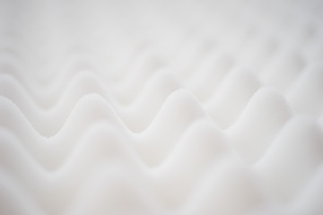 White gradient abstract background with many waves at different angles.