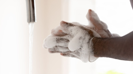 Close up of man wash clean hands with antibacterial soap liquid protect from covid-19 coronavirus outbreak, person take care of body hygiene, stop corona virus pandemic, healthcare concept