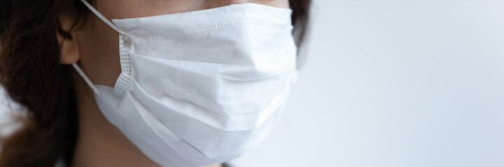 Close up banner view of young woman wear protective medical mask against coronavirus pandemic, female patient wearing facial cover protect from covid-19 pandemic spread, epidemic, corona concept