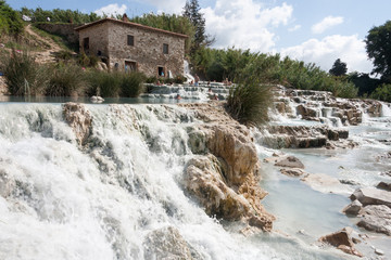 Gorello, Saturnia, Grosseto, Tuscany, Italy - May 29 2018: tourists swimming and relaxing in...