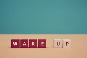 Waking up. Awakening. Good morning. Beginning new day. Wake up inscription on colorful wooden...