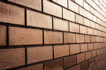 Brown brick wall in perspective. Abstract textured background. Space for text.