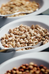 close-up tasty inshell pistachios in a ceramic bowl