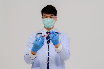 Doctors carrying an infected blood sample in a sample tube with DNA strains, coronavirus covid 19 vaccine research with the coronavirus vaccine 2019-nCoV COVID in a chemical research laboratory.