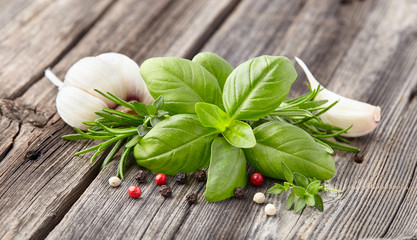 Fresh herbs and spices on wooden background
