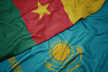 waving colorful flag of kazakhstan and national flag of cameroon.