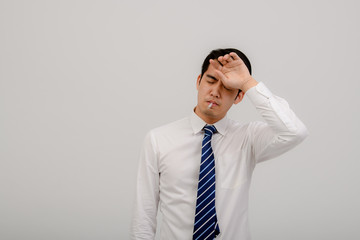 An Asian man, coughing, sneezing or having a runny nose and fever, has a Coronavirus reading his temperature on a thermometer. Isolated on white