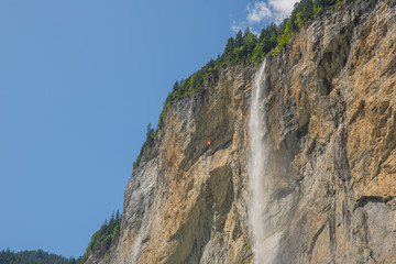 Spectacular waterfall from rocky cliff, Lauterbrunnen, Swiss Alps
