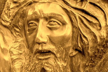 Fototapeta na wymiar Golden relief of Jesus