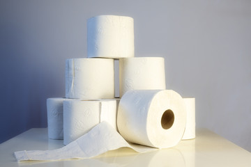 Stack of toilet paper rolls, lack in Germany after shoppers panic buying because of coronavirus pandemic outbreak, gray background with copy space