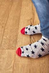 Funny socks. Legs of a young man in funny socks