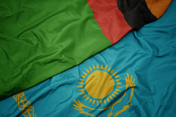 waving colorful flag of kazakhstan and national flag of zambia.