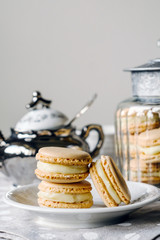Homemade macarons pastries with custard on the table