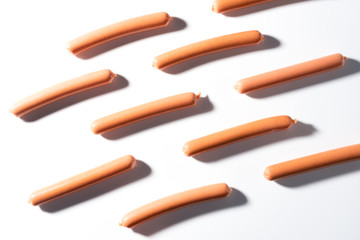 small sausages on a white background in a row