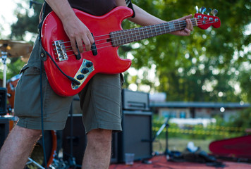 Close-up of bright electric bass guitar at Rock and roll concert