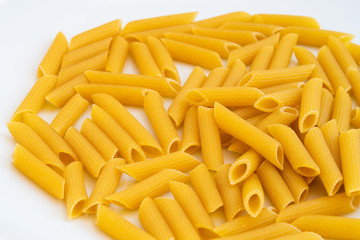 Close up of penne rigate pasta isolated on a white background