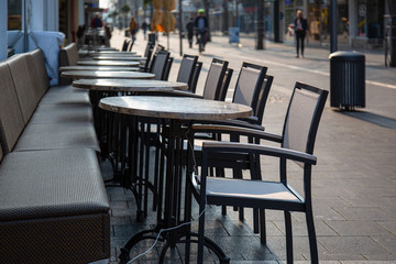Neuwied, Germany - March 20, 2020: tables and chairs in front of a  closed shop in the city center of Neuwied based on Corona pandemic