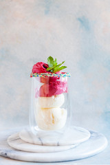 Tasty homemade multicolored popsicles ice cream with mint leaves in a glass cup